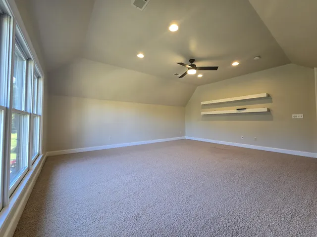 wooden floor in an empty room with a ceiling fan