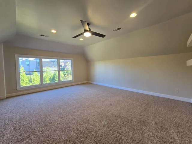 an empty room with a empty space and a ceiling fan