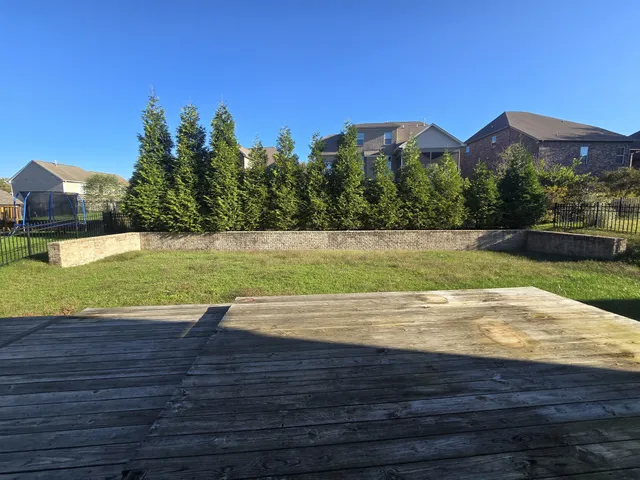 a view of a swimming pool with a yard