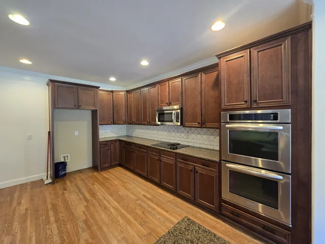 a kitchen with stainless steel appliances granite countertop a refrigerator stove and sink