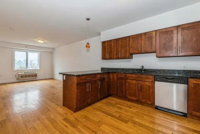 a kitchen with granite countertop wooden cabinets and a counter top space