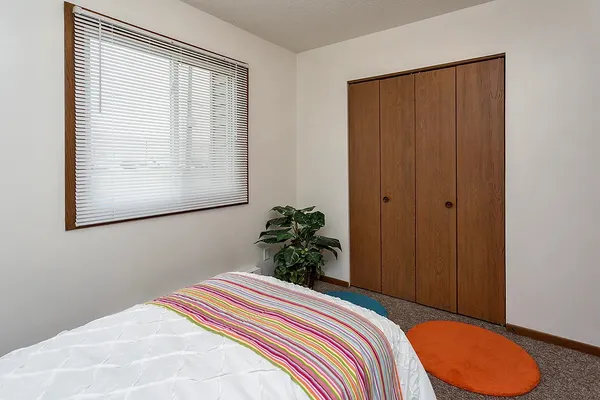 a bedroom with a bed and a window