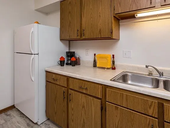 a kitchen with stainless steel appliances granite countertop a sink refrigerator and microwave