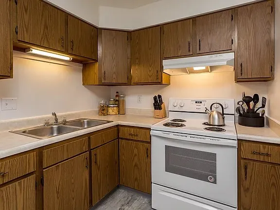 a kitchen with a sink stove and cabinets