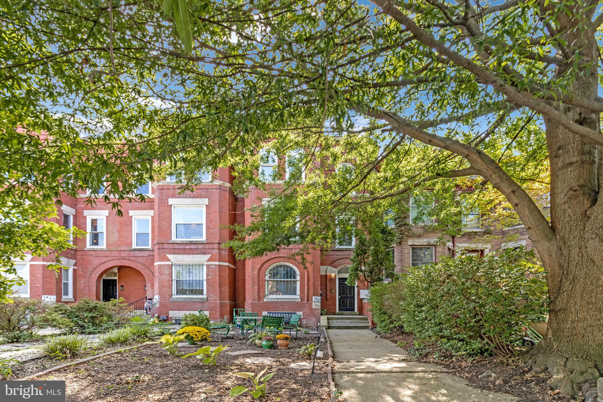 front view of a house with a tree