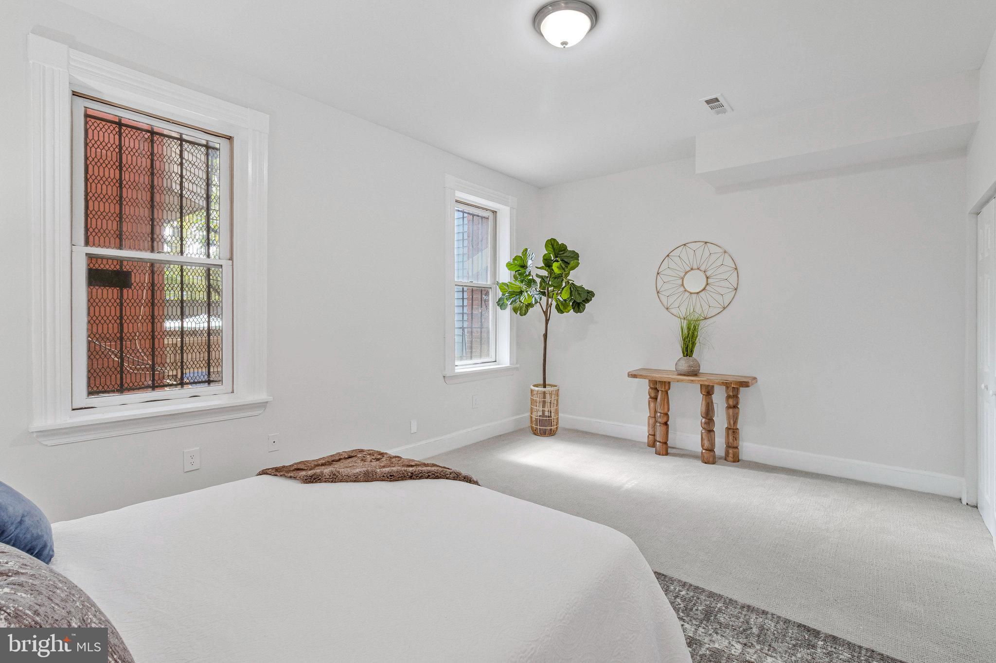 1443 East Capitol Street Southeast, Unit 1 Washington, DC 20003 - Photo 14 of 19 a bedroom with a bed and a window