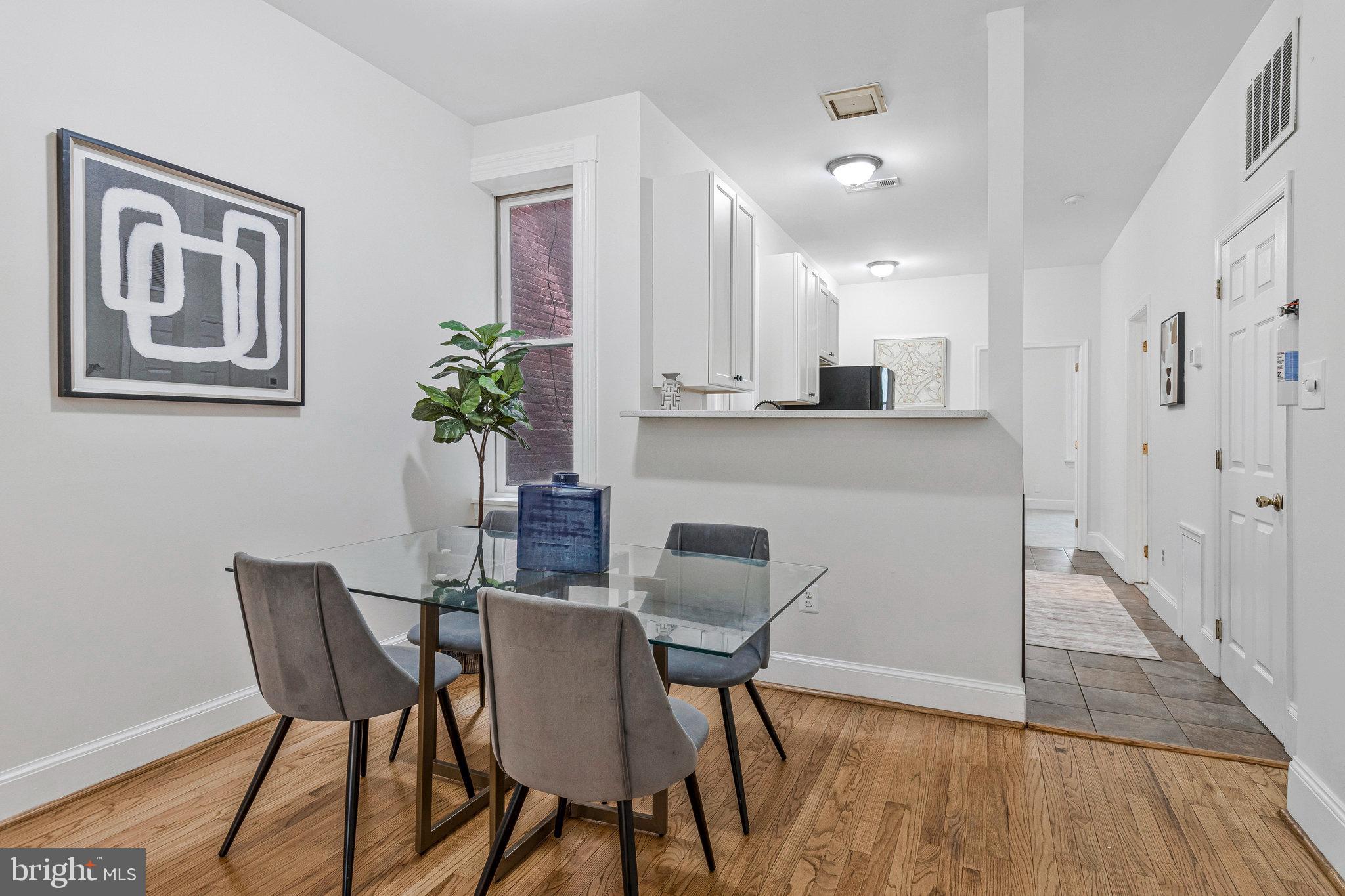 1443 East Capitol Street Southeast, Unit 1 Washington, DC 20003 - Photo 6 of 19 a view of a dining room with furniture and wooden floor