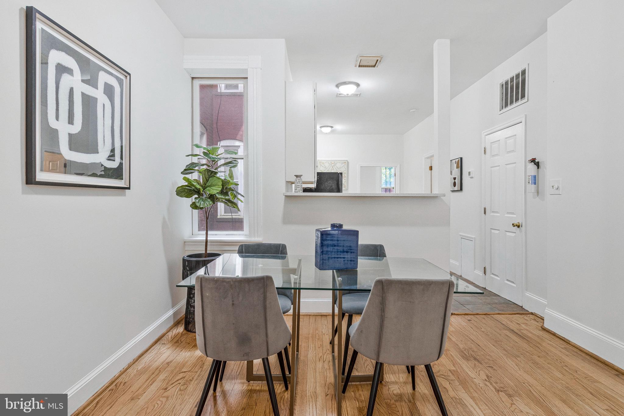 1443 East Capitol Street Southeast, Unit 1 Washington, DC 20003 - Photo 7 of 19 a view of a dining room with furniture window and wooden floor
