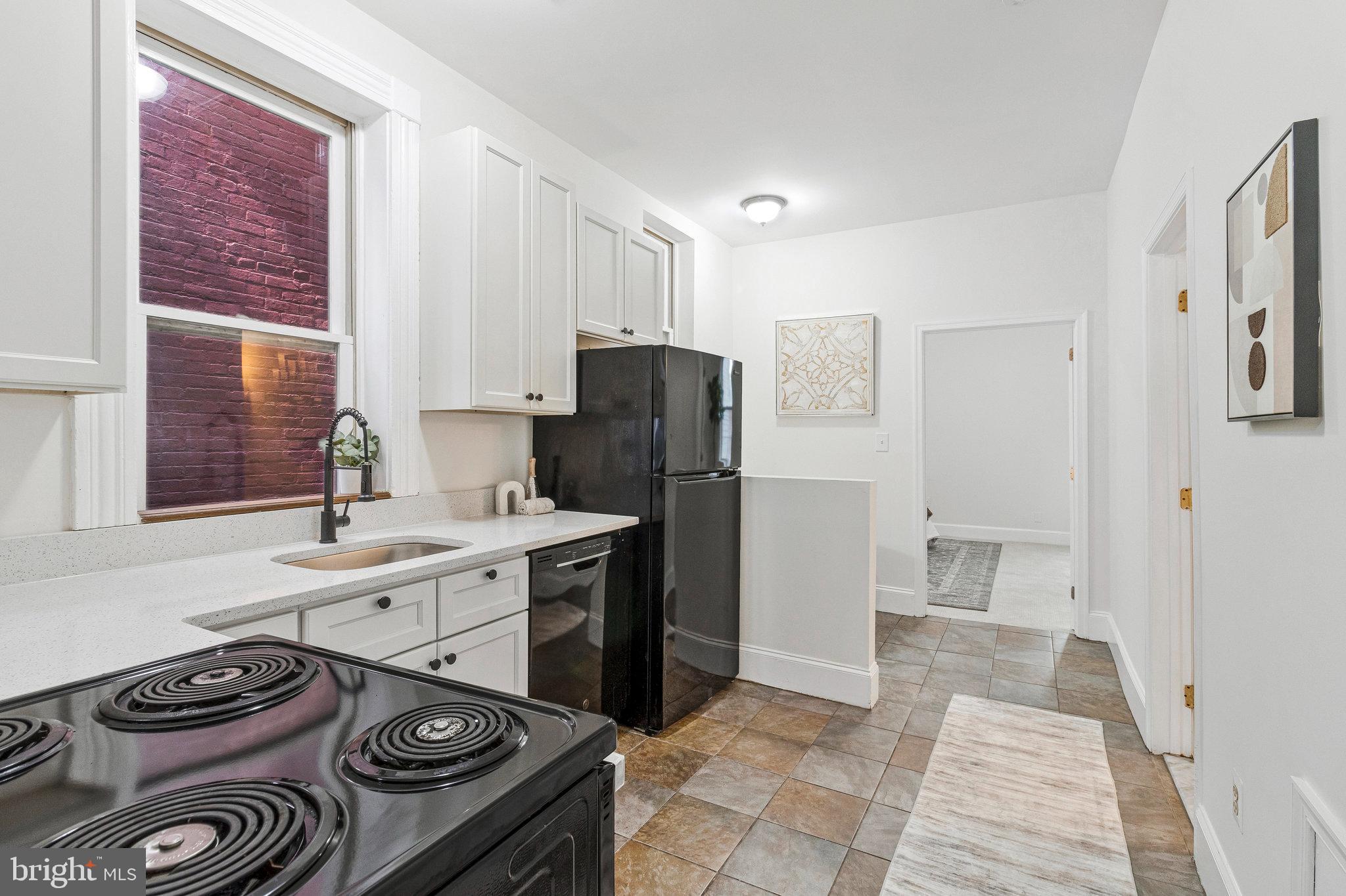 1443 East Capitol Street Southeast, Unit 1 Washington, DC 20003 - Photo 8 of 19 a kitchen with a stove and a refrigerator