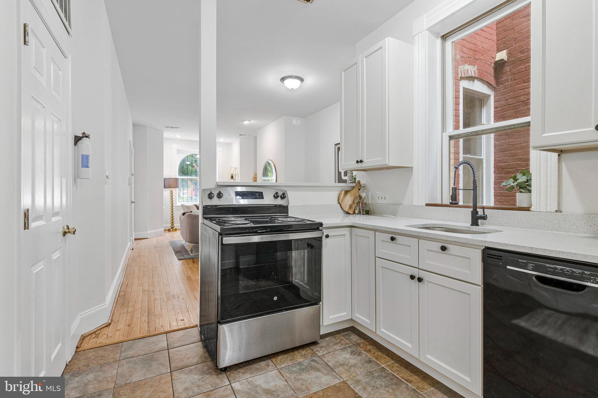 1443 East Capitol Street Southeast, Unit 1 Washington, DC 20003 - Photo 9 of 19 a kitchen with stainless steel appliances granite countertop a stove a sink and a refrigerator