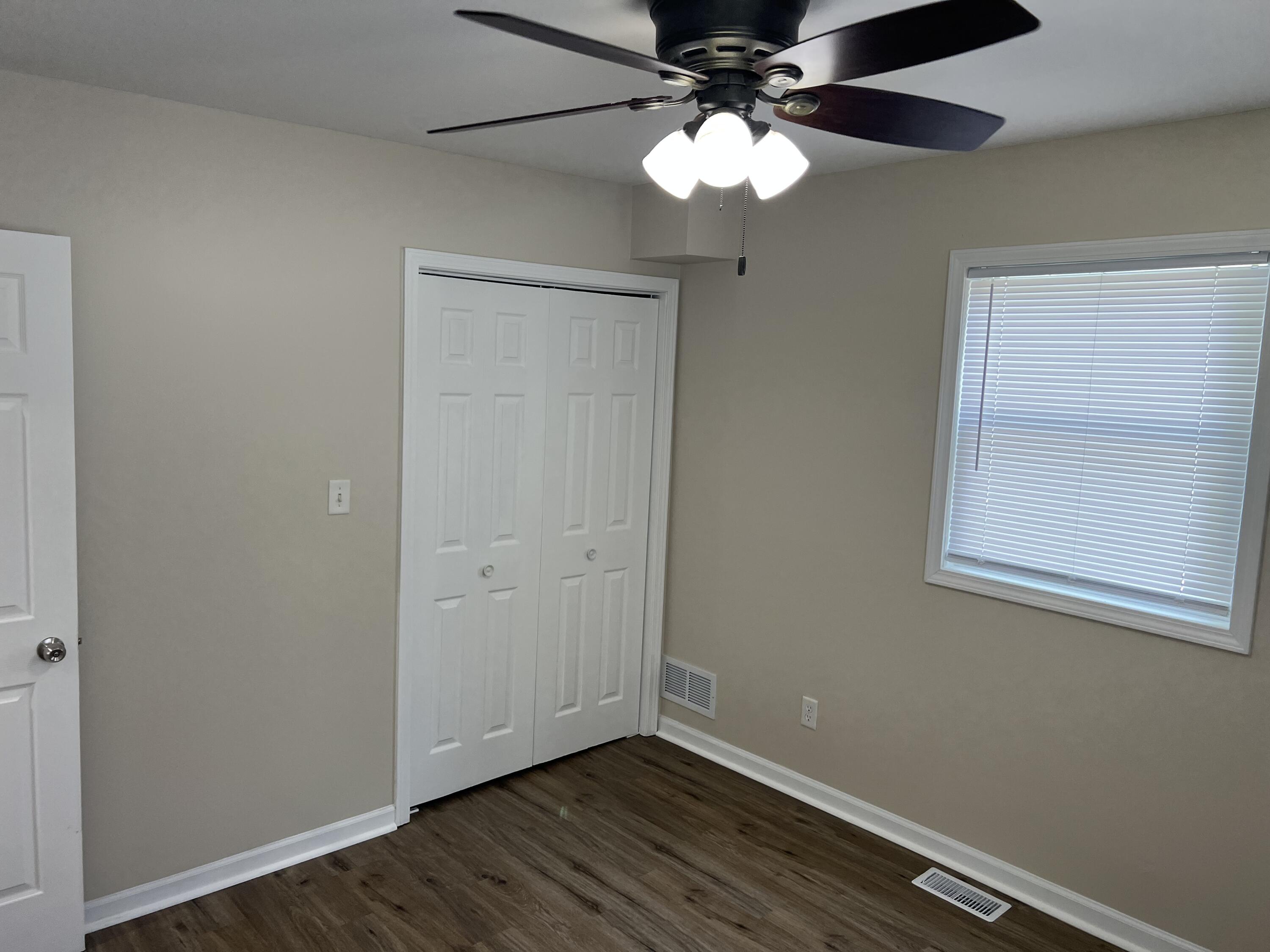3851 Maple Street Hobart, IN 46342 - Photo 11 of 28 an empty room with wooden floor chandelier fan and closet area