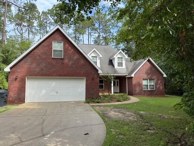 2069 County Highway 83A East Freeport, FL 32439 - Photo 1 of 26 a front view of a house with a yard and garage