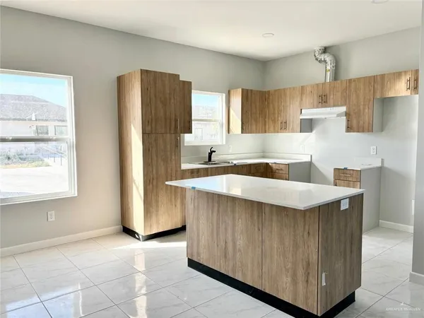 a kitchen with stainless steel appliances a sink a refrigerator and a stove