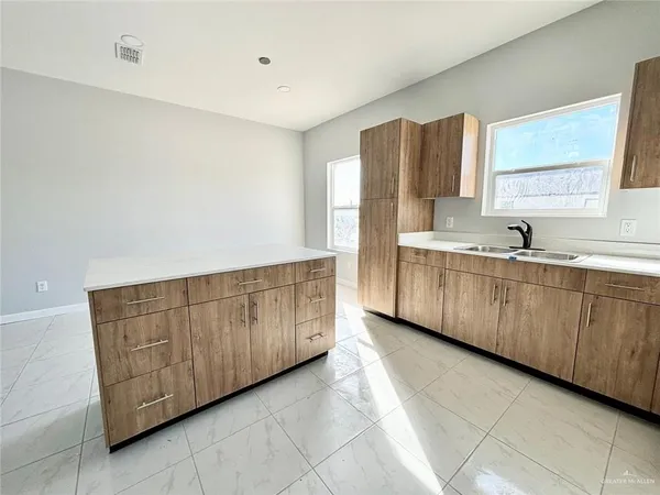 a kitchen with wooden cabinets