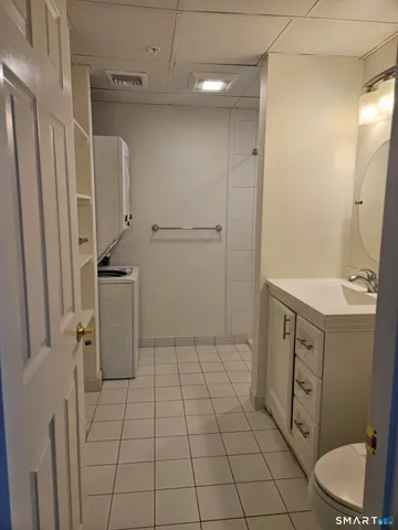 a bathroom with a sink a toilet and a mirror