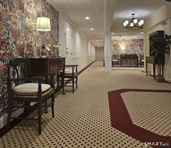 a dining room with furniture and a floor to ceiling window