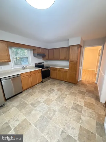 a kitchen with stainless steel appliances a cabinets a sink and a stove