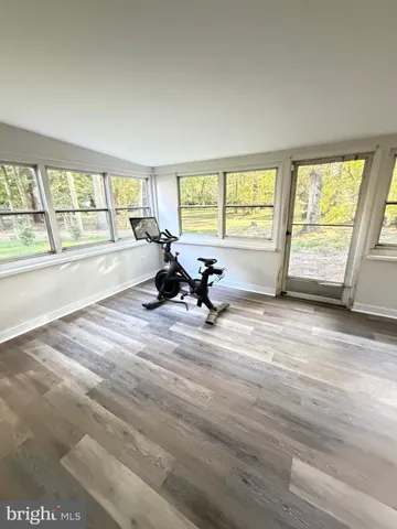 a view of room with wooden floor and furniture