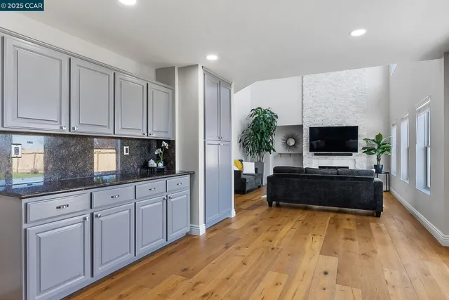 a living room with stainless steel appliances microwave stove and cabinets