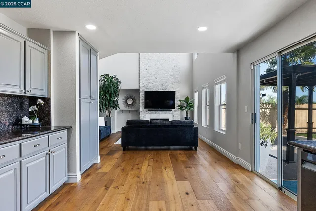 a living room with furniture a flat screen tv and a fireplace