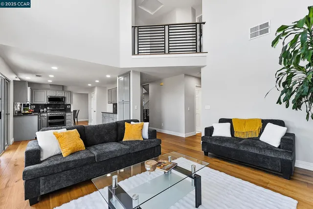 a living room with furniture and kitchen view