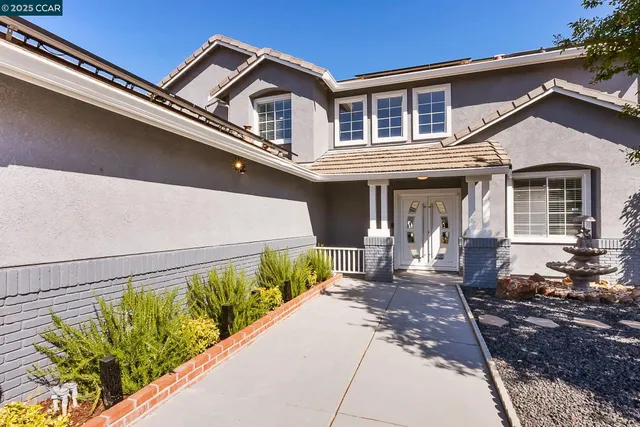 a front view of a house with a yard outdoor seating