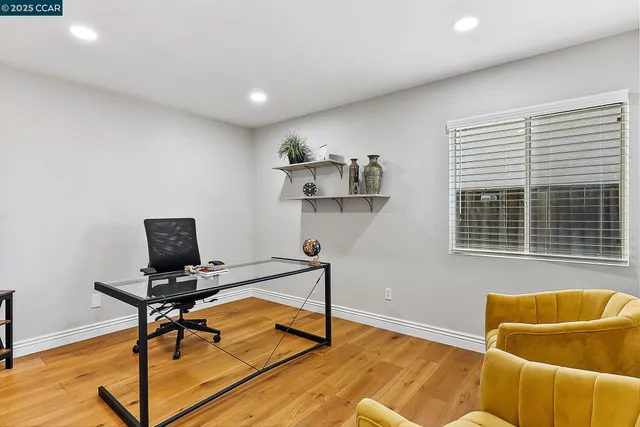 a view of workspace with wooden floor windows