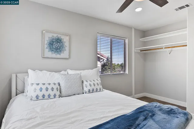 a bedroom with a large bed and a window