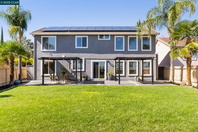 front view of a brick house with a yard