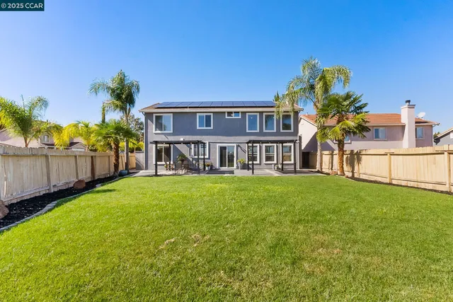 a view of a house with a yard and deck