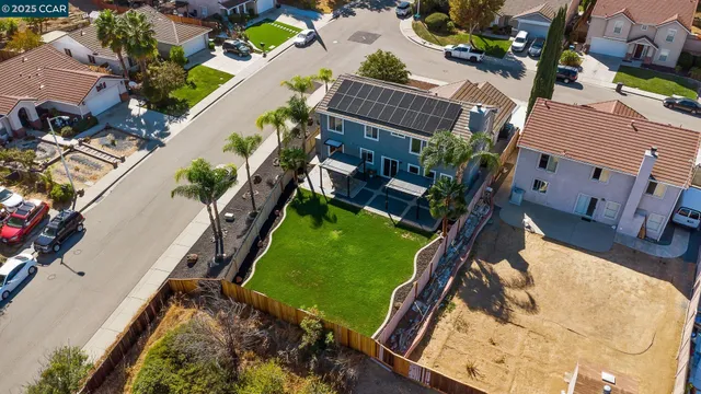 an aerial view of a house with a garden and swimming pool