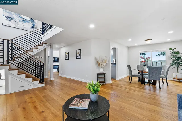 a living room with furniture and a dining table