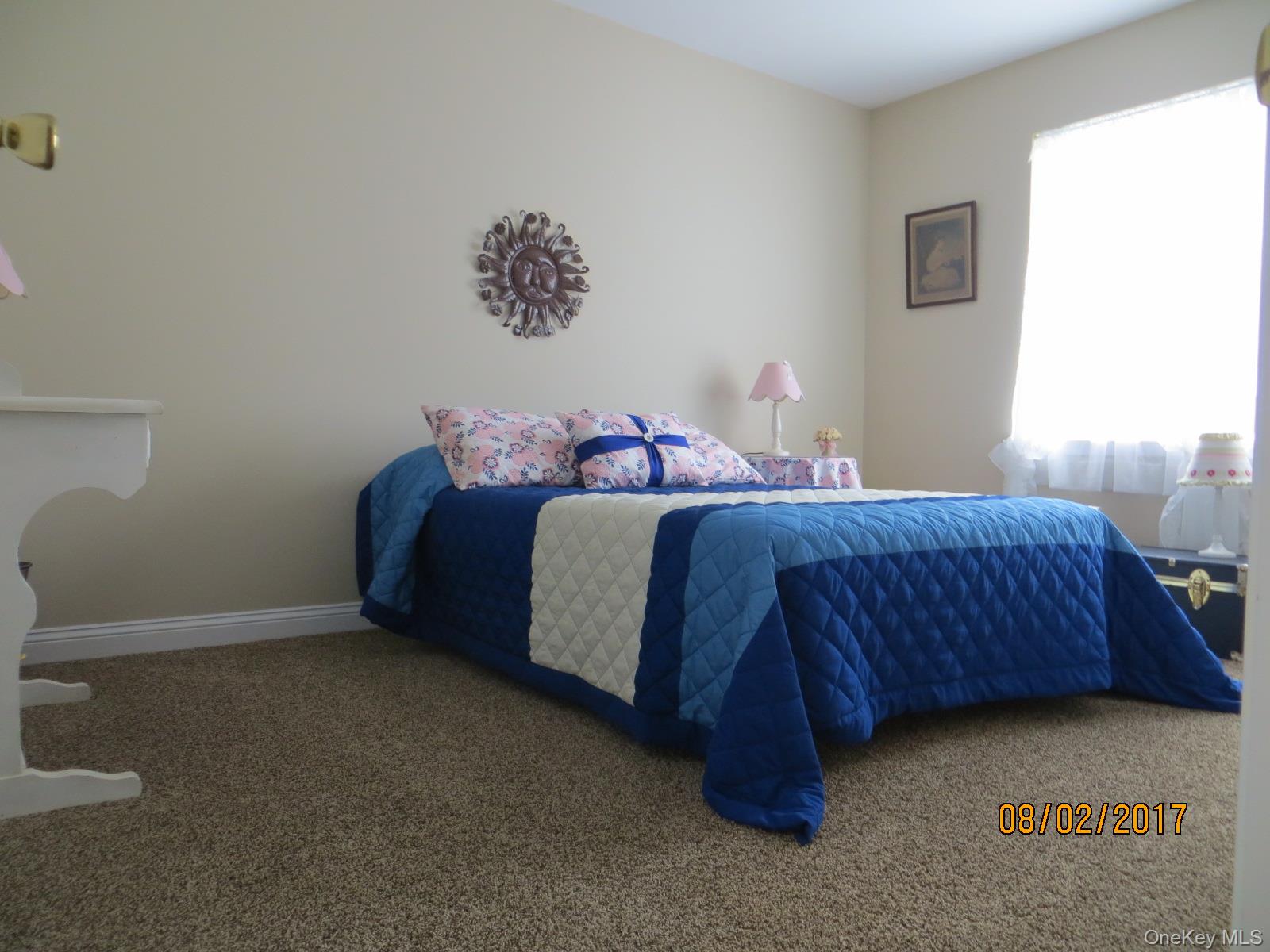 215 Rabbit Run Road Plattekill, NY 12515 - Photo 9 of 14 a bedroom with a bed and a lamp on the dresser