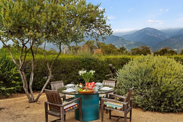 a backyard of a house with table and chairs