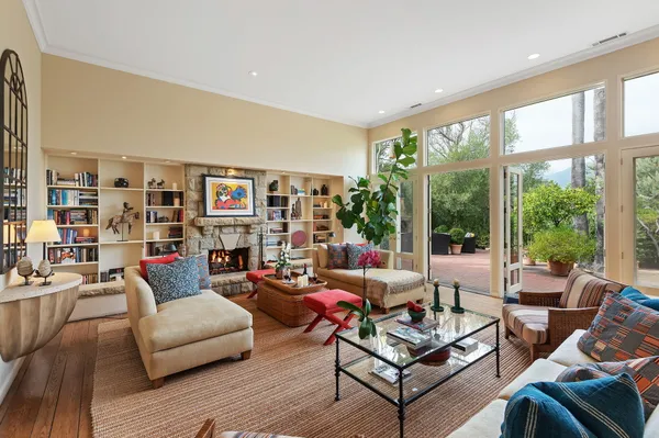 a living room with furniture a rug and a large window
