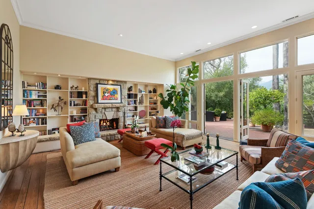 a living room with furniture a rug and a large window
