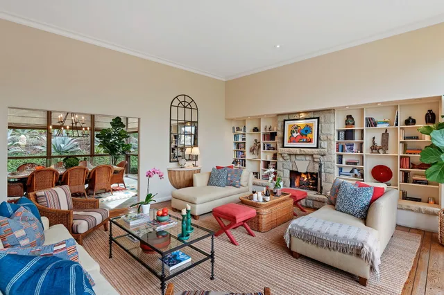 a dining room with furniture water view and large windows