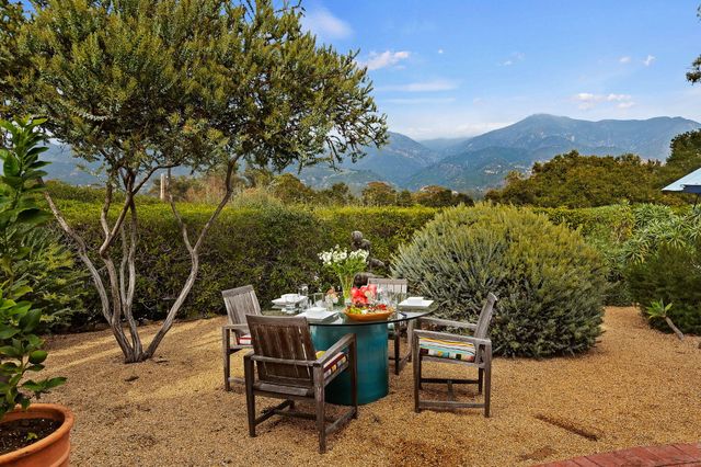 a view of a chairs and table in patio