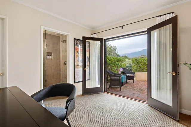 a front view of a house with outdoor seating