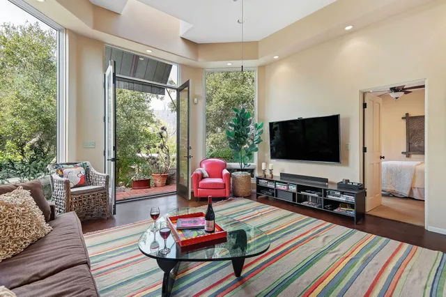 a bedroom with a large bed and a chandelier