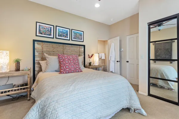 a bedroom with a large bed and a large window