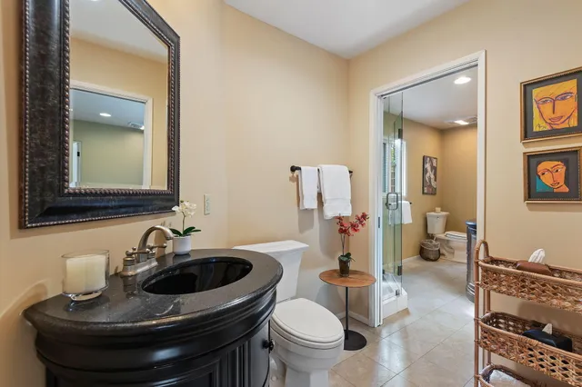 a bedroom with a bed a couch and a large window