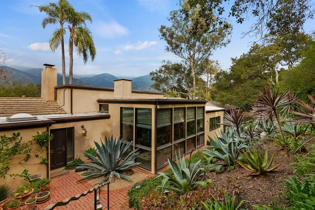 a view of a house with a window and wooden fence