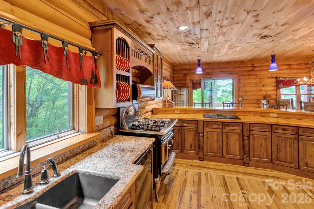 35 Falcon Crest Loop Maggie Valley, NC 28751 - Photo 13 of 46 a kitchen with a sink and wooden cabinets