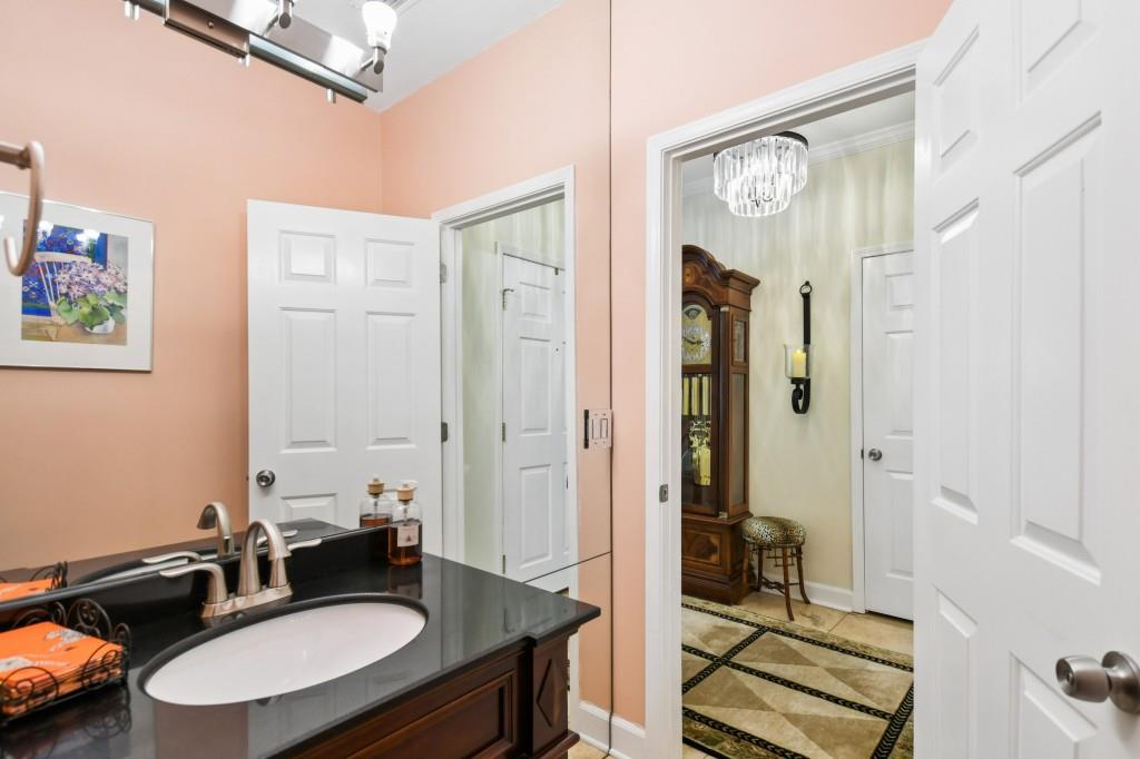 2921 Lenox Road Northeast, Unit 103 Atlanta, GA 30324 - Photo 16 of 37 a bathroom with a sink double vanity and a mirror