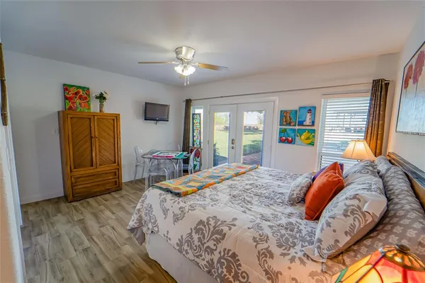 a bedroom with a bed and a chandelier