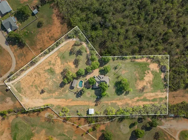 an aerial view of a houses with ocean view