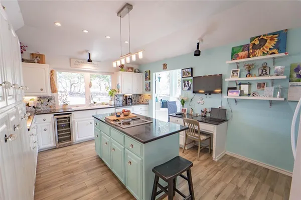 a kitchen with sink and large mirror