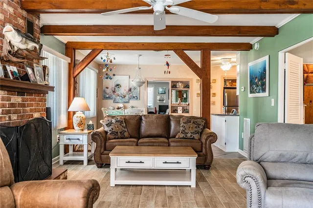 a living room with furniture fireplace and flat screen tv