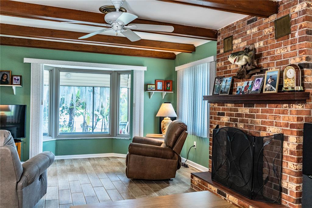 1305 Arbuckle Creek Road Sebring, FL 33870 - Photo 13 of 71 a living room with furniture and a fireplace